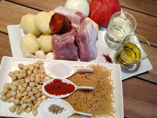 Ingredientes del rancho canario: garbanzos, fideos, costillas de cerdo, chorizo, tocino, papas, cebolla, ajo, tomate, especias y aceite de oliva.