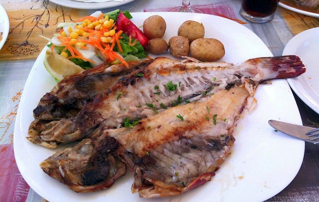 Platos principales: Vieja a la espalda, un plato tradicional canario con pescado fresco, papas arrugadas y mojo verde.